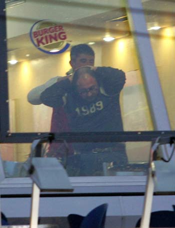 A gunman, back, takes hostage an unidentified man in a fast Food restaurant in downtown Istanbul, Turkey (AFP)