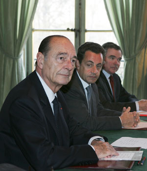 French President Jacques Chirac (L) attends a meeting with French Interior Minister Nicolas Sarkozy (C) and Prime Minister Dominique de Villepin (out of picture) on the CPE (First Employment Contract), 10 April 2006 (AFP)