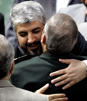 Hamas leader Khaled Meshaal (L) hugs Iran's Revolutionary Guards Commander Rahim Safavi during the opening ceremony of the International Conference on Al-Quds and Support for the Rights of Palestinian People in Tehran, Iran, April 14, 2006 (REUTERS)