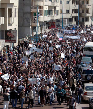 Egyptian Christians carrying banners walk in a funeral procession during the funeral of a victim after a series of simultaneous attacks against three churches in Alexandria, 15 April, 2006 (EPA)