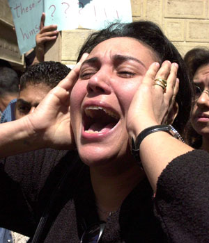 An Egyptian Coptic Christian woman cries during the funeral of a fellow Copt who was stabbed during a church service in the mediterranean city of Alexandria, 15 April 2006 (AFP)