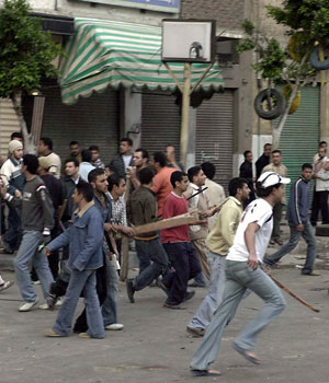 Egyptian Muslims and Copts attack each other with sticks after the funeral of a Coptic Christian who was stabbed during a church service in the mediterranean city of Alexandria, 15 April 2006 (AFP)