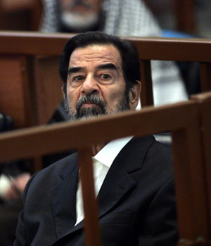 Former Iraqi President Saddam Hussein listens to prosecutors during his trial held under tight security in Baghdad's heavily fortified Green Zone, April 19, 2006 (AP)