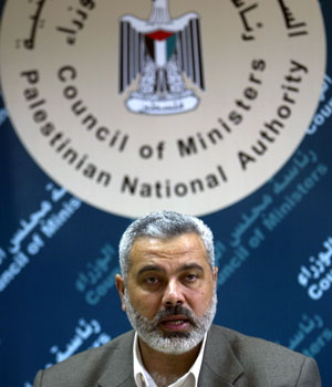 Palestinian Prime Minister Ismail Haniya speaks with police officers during a meeting with Hamas supporters in the Palestinian Security Forces in Gaza City, 19 April 2006 (AFP)