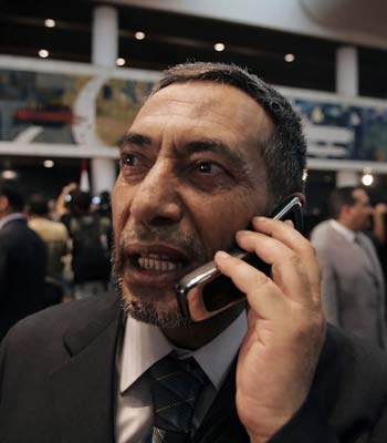 Iraq's newly-elected Parliament Speaker Mahmud Mashhadani speaks on the telephone following a parliament session (AFP)