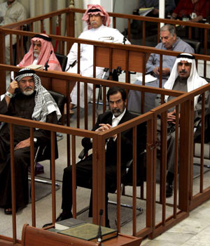 Former Iraqi President Saddam Hussein and seven co-defendants (not all seen) are on trial for torture, illegal arrests and the killing of nearly 150 people from Dujail after a 1982 assassination attempt on Saddam in the town (EPA)