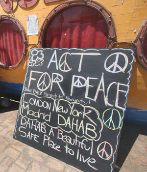 Tota Dance Bar menu board carries a message of peace that says "Stop All Violence Everywhere," following a terrorist attack in which three bombs were detonated in the Red Sea resort of Dahab, Egypt (EPA)