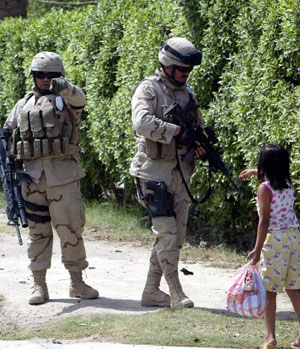 US soldiers prevent people from entering the scene where a car bomb exploded in al-Yarmouk district in western Baghdad, 13 June 2005 (EPA)