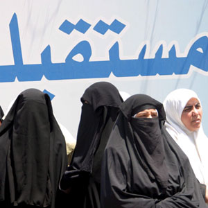 Iraqi women watch the funeral procession for Mayson Hashimi, the sister of Iraqi vice-president Tarik Hashimi, in Baghdad on Thursday, 27 April 2006