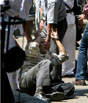 Egyptian police arrest an injured protester during clashes in Cairo May 11, 2006 (REUTERS)