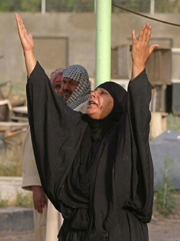 An Iraqi Shi'ite woman screams during the funeral of her son who was killed in Sadr city in Baghdad (R)