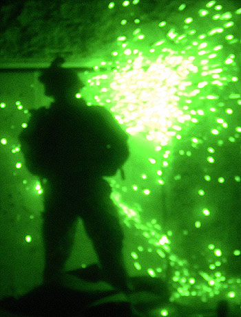 US soldier uses a saw to gain entry into a store in Siniya (R)