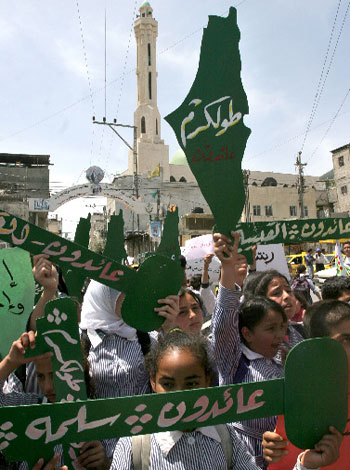 Palestinian schoolgirls shout slogans during a rally to mark the 58th anniversary of "al-Nakba," (AP)