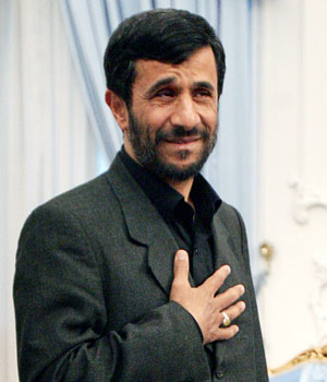 Iranian President Mahmoud Ahmadinejad greets journalists as he waits for a meeting with Chief of the Organisation of the Islamic Conference (OIC) Ekmeleddin Ihsanoglu in Tehran June 2, 2006 (REUTERS)