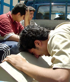 Iraqis mourn over a coffin of their relative outside a local hospital in Baghdad, 06 June 2006 (AFP)