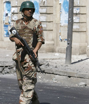 Iraqi soldier secures scene of roadside bomb in central Baghdad, June 6, 2006 (REUTERS)