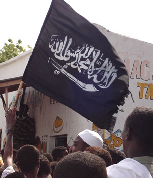 Somali supporters of the Islamic Courts Union hold an Islamic flag, June 6, 2006 during a rally in Mogadishu (AP)