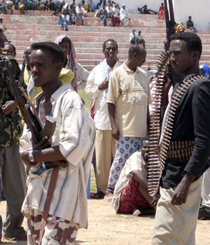 Gunmen allied to the US backed warlords guard a rally in the northern Mogadishu Abgal stadium during a rally called by the warlords to address their supporters about the loss of Mogadishu, 06 June 2006 (AFP)