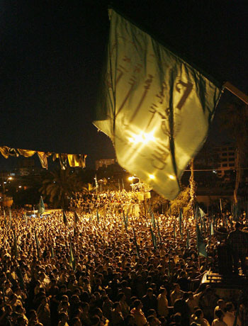 Hamas supporters attend a rally against Israeli air strikes in Gaza (R)