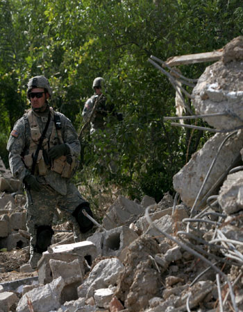 A US Army 4th Infantry Division soldier guards the scene of the recent air strike against Abu Musab al-Zarqawi (EPA)