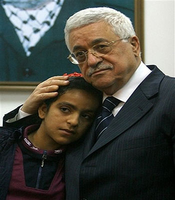 Palestinian President Mahmoud Abbas holds Houda Ghalia as he meets her in his office in Gaza City (AP)