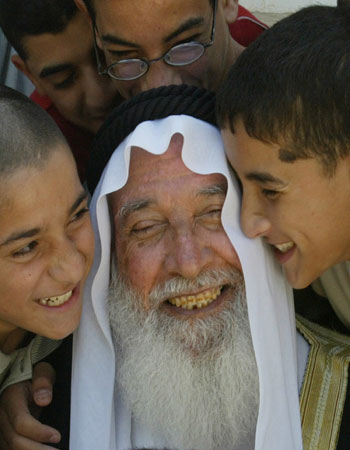 Jordanian Islamist deputy Mohammed Abu Faris is embraced by his children and grandchildren at his home in Sweilah near Amman (R)