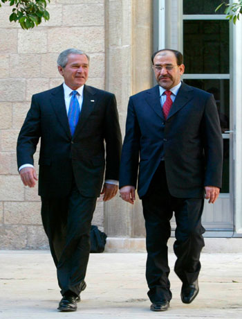 President George W. Bush, walks with Iraqi Prime Minister Nouri al-Maliki, before their meeting at the U.S. Embassy in Baghdad (AP)