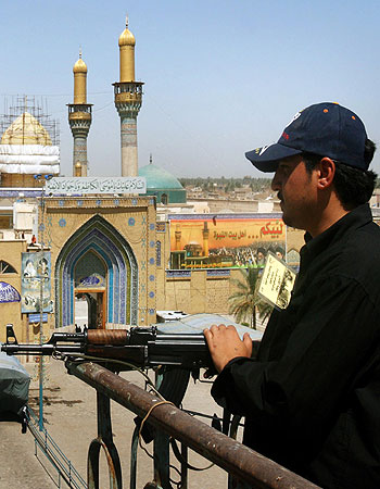 A security guard keeps watch over the Shiite Shrine of Imam Kadim in the Kazimiyah area of Baghdad (AP)