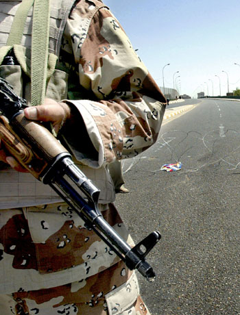 An Iraqi soldier secures an empty street in central Baghdad (AFP)