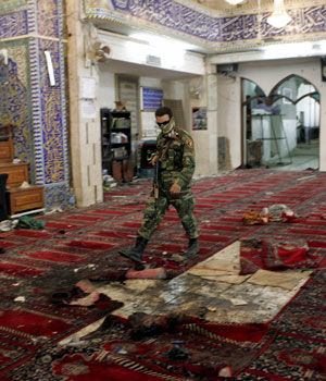 An Iraqi security member inspects the site of a suicide attack inside the Shiite Al-Buratha mosque, in Baghdad, on Friday 16 June 2006 (EPA)