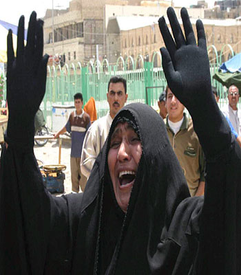 An Iraqi woman mourns the death of her relative who was killed in a suicide bomb attack, during the funeral in Najaf, south of Baghdad (EPA)