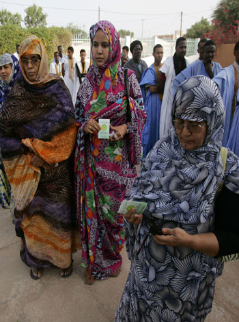 Woman stand in a queue as they wait to vote in the country-wide referendum in the city of Nouakchott, Mauritania (AP)