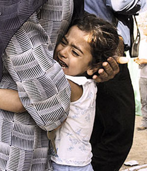 A Palestinian child cries after car bomb exploded in Gaza City, 27 June, 2006 (REUTERS)