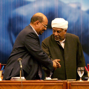 Mohammed Osman al-Mirghani (C), head of the opposition National Democratic Alliance (NDA), chats with Sudanese President Omar al-Beshir (L) (AFP)