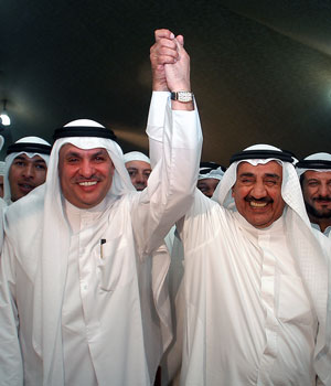 Outgoing parliament speaker Jassem al-Khorafi (R), a government ally, and opposition candidate Mohammad al-Saqer celebrate their victory in the Gulf emirate's parliamentary elections early 30 June 2006 in Kuwait City (AFP)