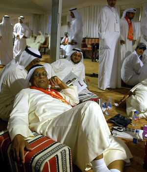 Kuwaitis wait for the results of the Gulf emirate's parliamentary elections inside one of the campaign tents early 30 June 2006 in Kuwait City (AFP)