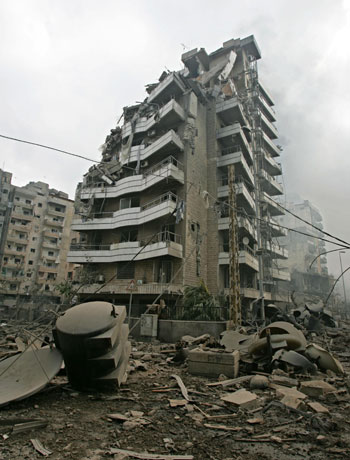 A destroyed building stands next to the headquarters of Hezbollah in the suburbs of Beirut (AP)