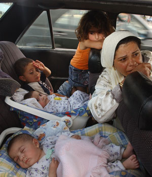 Women and children of the Ismaili family who fled the southern Lebanese village of Tyre, arrive in the port city of Sidon, Lebanon, July 17, 2006 (AP)