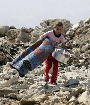 A Lebanese girl crosses a destroyed bridge in the village of Ferzoul, near Zahle city in the Bekaa valley 20 July 2006 (AFP)
