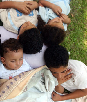 Lebanese displaced children from the south of the country take a nap as they find temporary shelter in the municipality of the southern port town of Sidon, Lebanon, July 22, 2006 (AP)