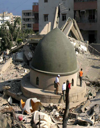 Lebanese civilians inspect a mosque that was demolished in Sidon, south Lebanon (R)