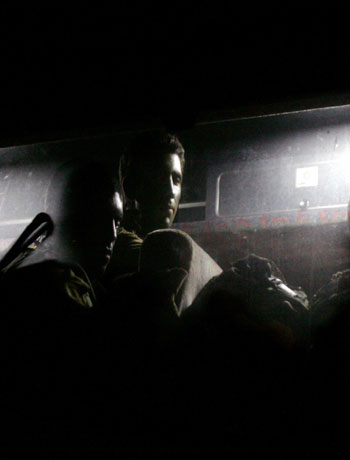 Israeli soldiers wait on a bus before a night operation close to the Israel-Lebanon border (AP)