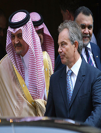 Britain's PM Blair leaves Downing Street with the Saudi Foreign Minister Saud Al Faisal in London (R)