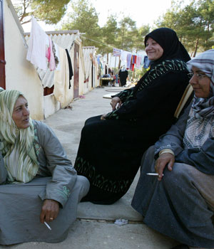 Lebanese women who fled their war-torn country smoke cigarettes at a tourist camp turned into a refugee center in Zabdani, 40km west of Damascus, 26 July 2006 (AFP)