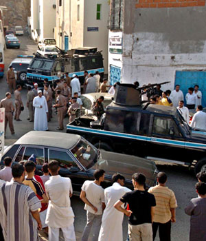 Saudis stand watching at the scene where security forces killed two suspected terrorists Tuesday, June 21, 2005, on the outskirts of Mecca, accused of murdering a senior Saudi security official in Mecca three days ago (AP)