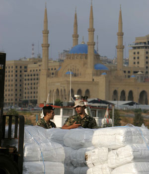Lebanese soldiers talk as U.S. Navy unloads the humanitarian supplies delivered by the US HSV 2 Swift at the port of Beirut, July 29, 2006 (AP)