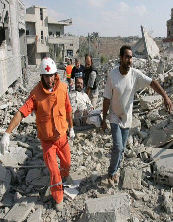 Rescue workers carry an injured Lebanese man on a stretcher after an Israeli air strike on the village of Qana (EPA)