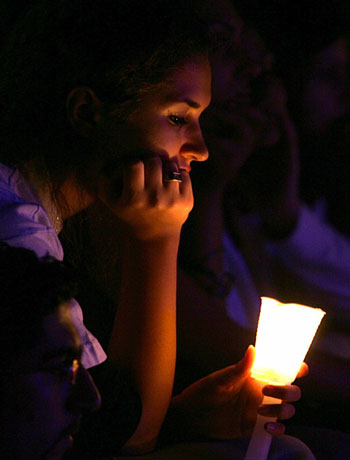 A Jordanian holds a candle during a fund-raising concert in support of Lebanon in Amman(R)