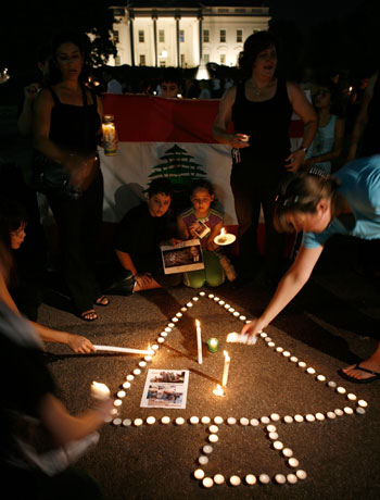 Demonstrators light candles in front of the White House (AFP)