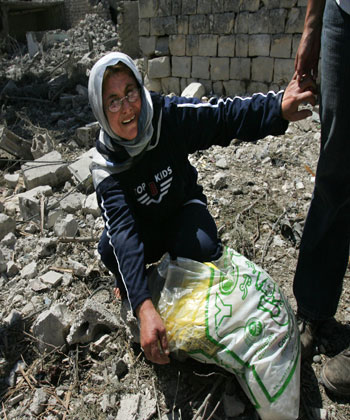 A Lebanese woman weeps as she sits in the rubble from Israeli missile strikes (AP)